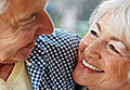 Close up of elderly man and woman smiling at one another
